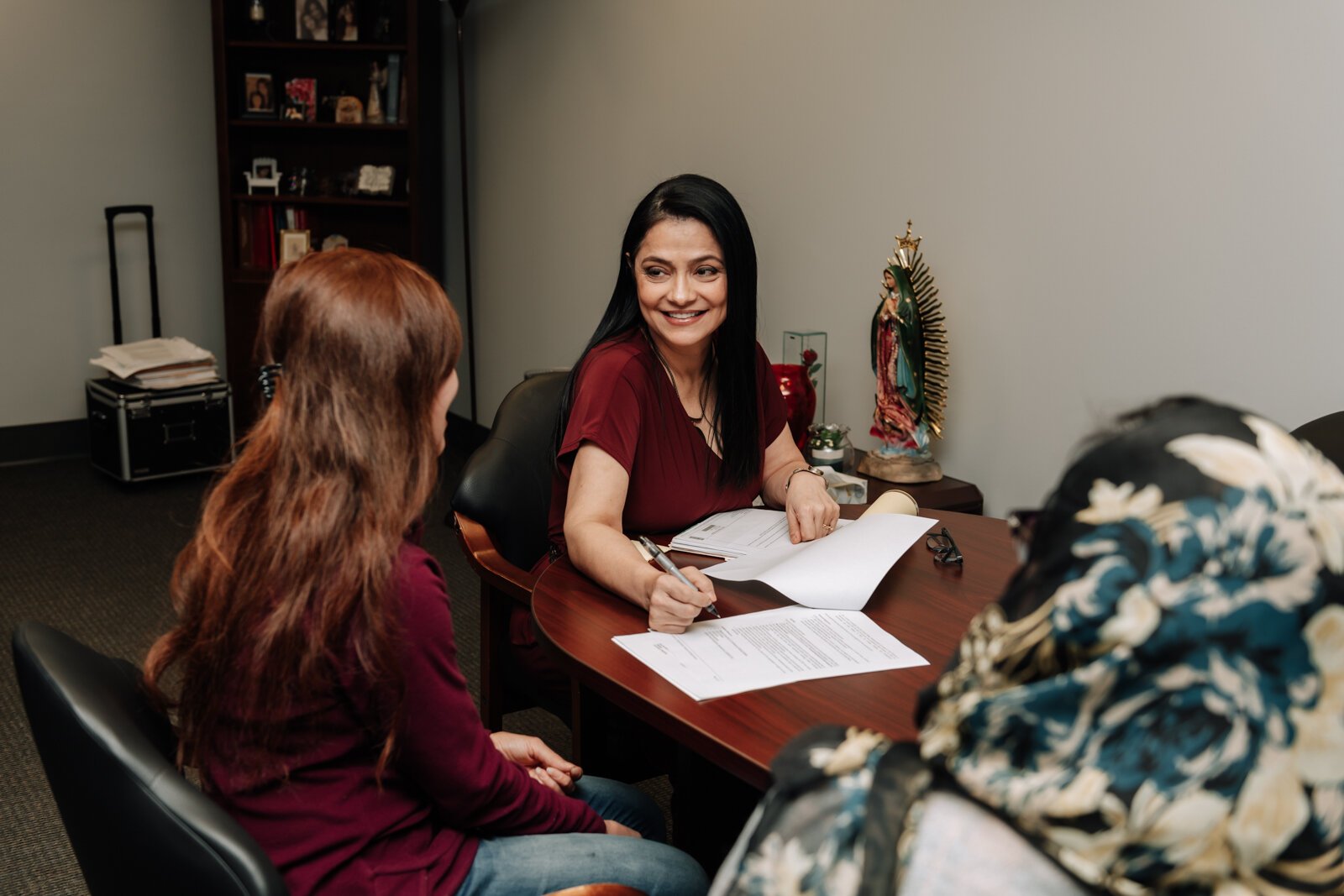 Luz Ostrognai with Catholic Charities demonstrates what a meeting with immigration clients would look like at the Archbishop Noll Catholic Center.