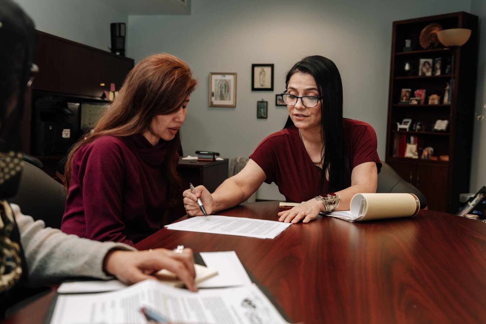 Luz Ostrognai with Catholic Charities demonstrates what a meeting with immigration clients would look like at the Archbishop Noll Catholic Center.