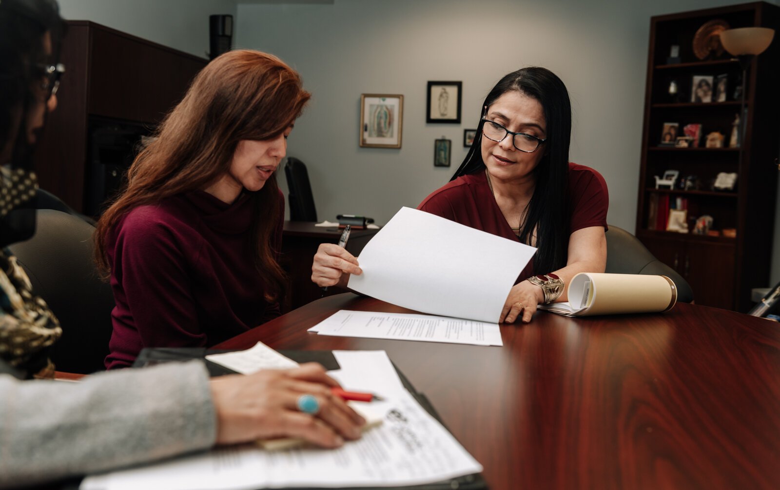 Luz Ostrognai with Catholic Charities demonstrates what a meeting with immigration clients would look like at the Archbishop Noll Catholic Center.