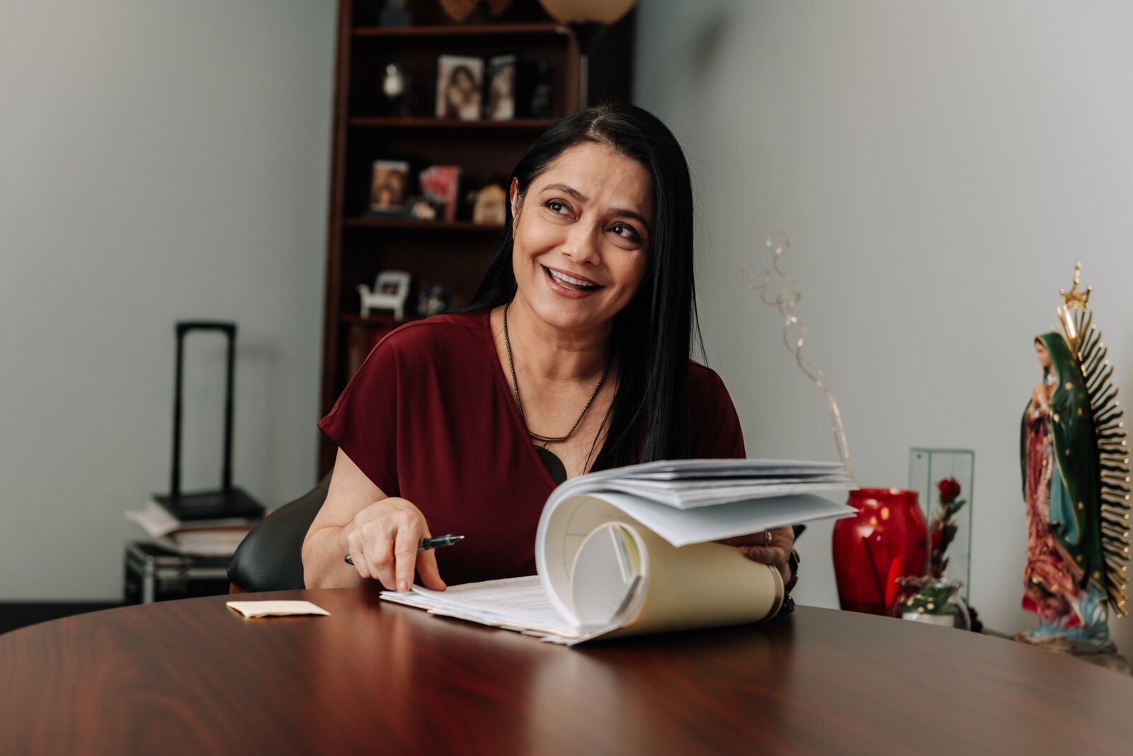 Luz Ostrognai with Catholic Charities works in her office at the Archbishop Noll Catholic Center.