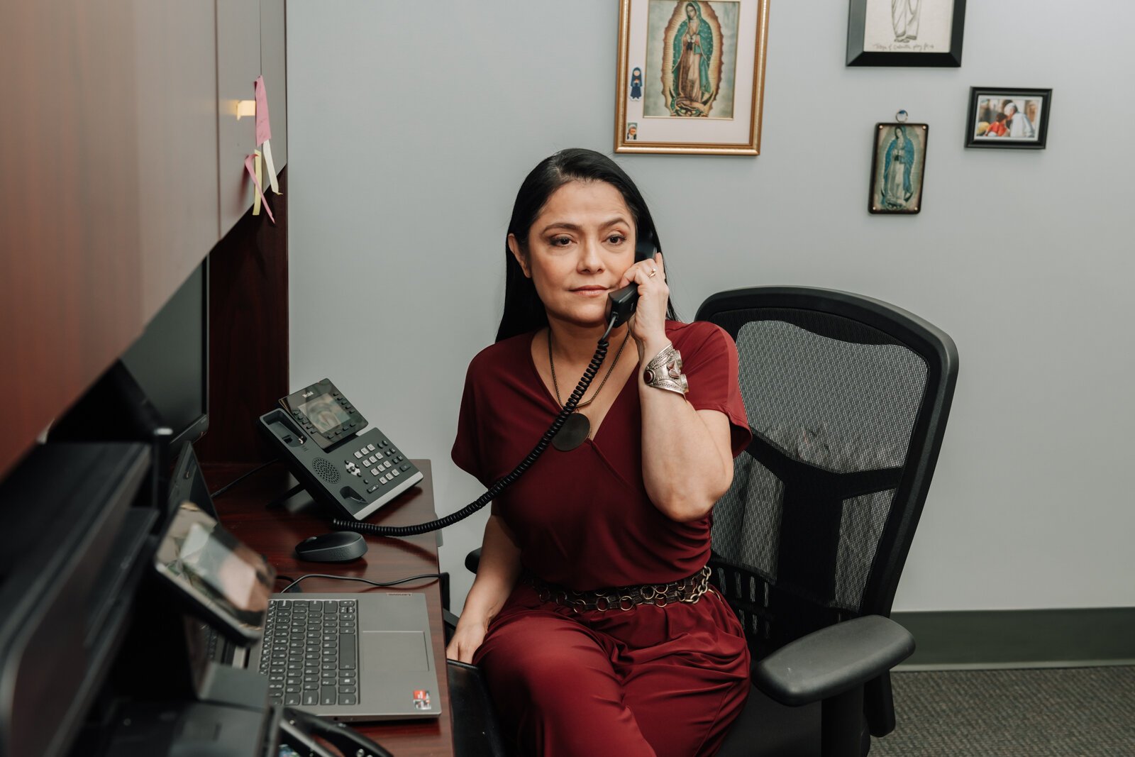 Luz Ostrognai with Catholic Charities works in her office at the Archbishop Noll Catholic Center.