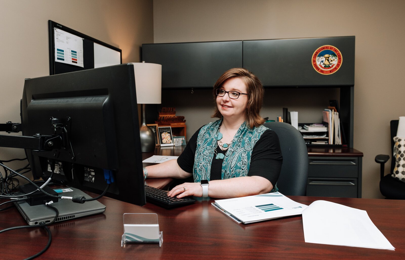 Emily Almodovar, Public Information Officer at Allen County works at her desk at Citizens Square.