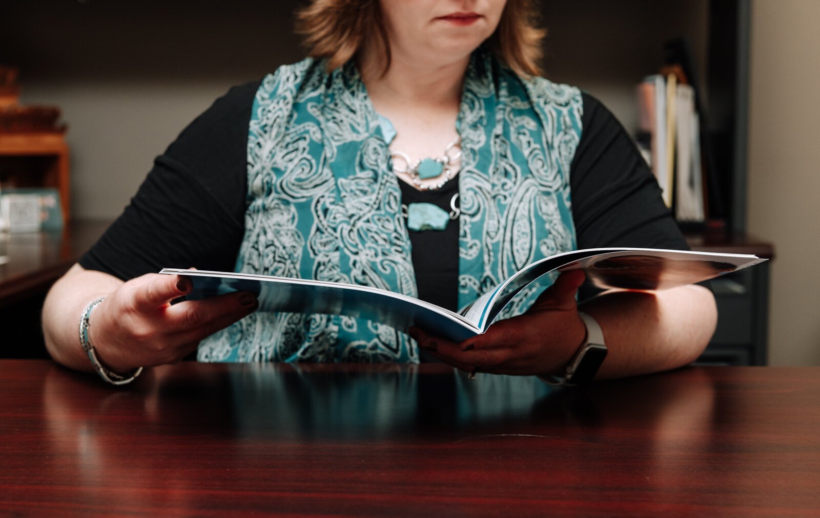 Emily Almodovar, Public Information Officer at Allen County looks at an Allen County Department of Health Annual Report.