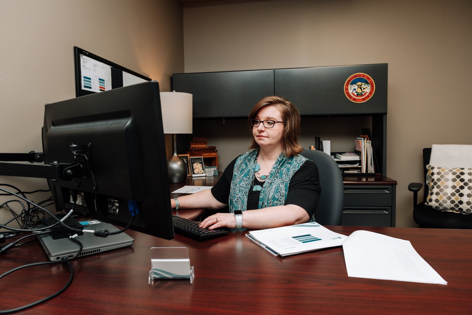 Emily Almodovar, Public Information Officer at Allen County works at her desk at Citizens Square.