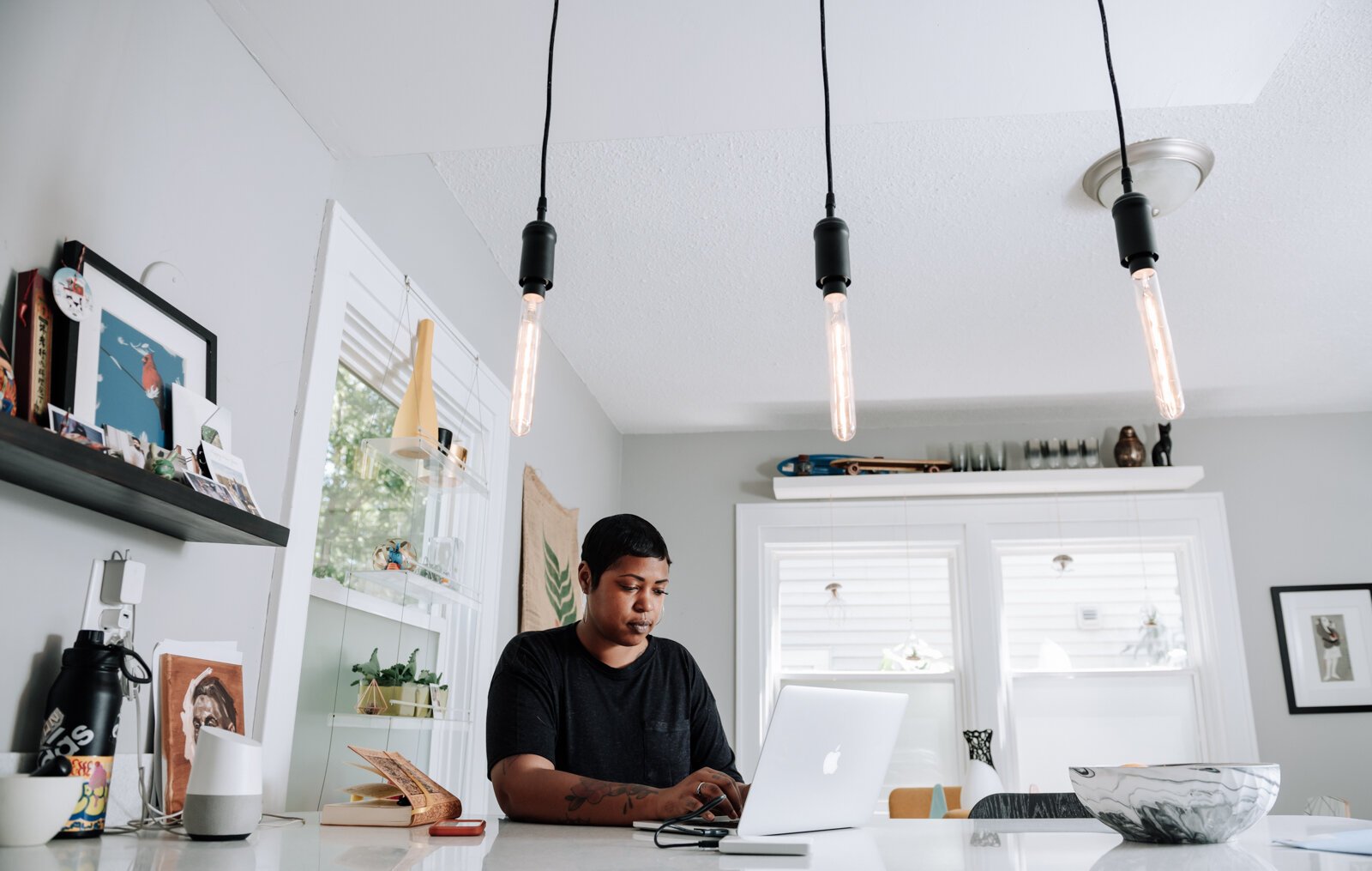 Creative Writer Shanel Turner works on writing in one of her favorite workspaces in the kitchen at her home in the '07.