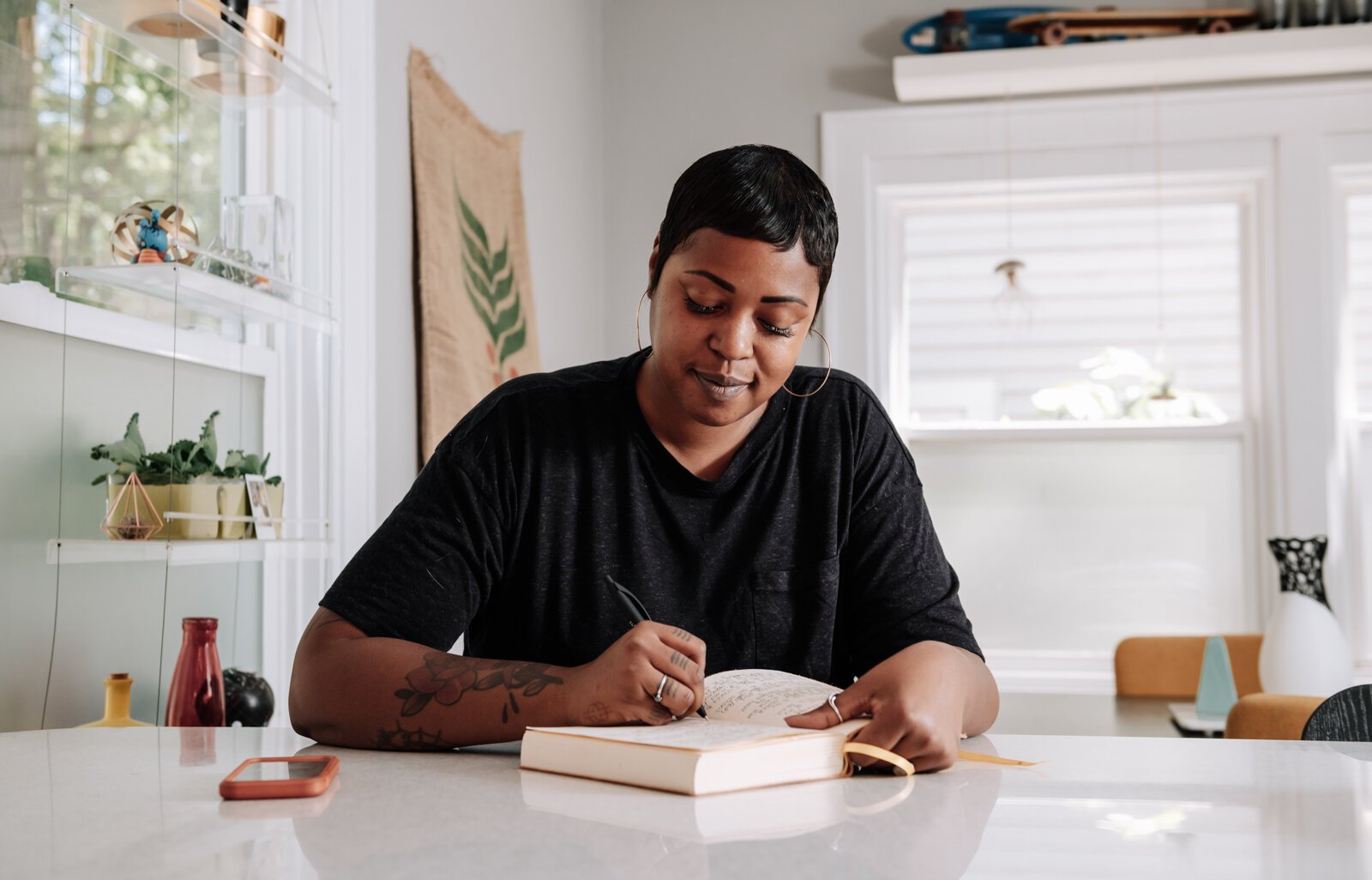 Creative Writer Shanel Turner works on writing in one of her favorite workspaces in the kitchen at her home in the '07.
