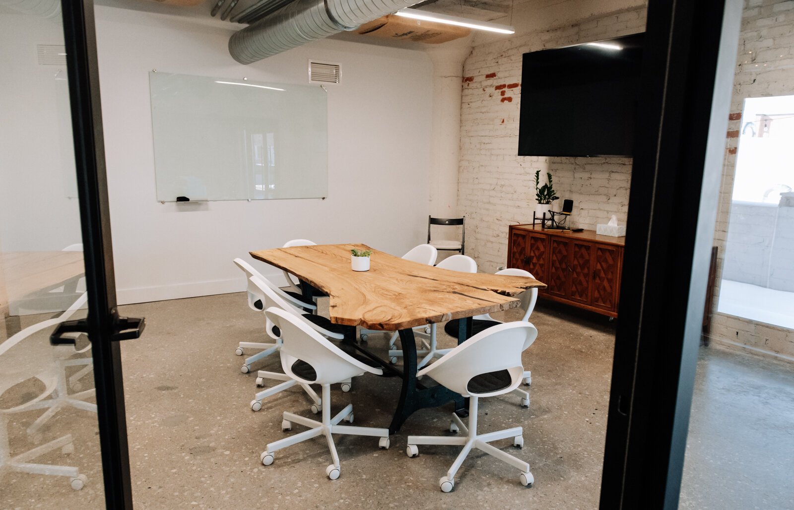 The co working space at Paper Mill Workspace is light and airy and features many different size offices as well as a conference room on the 4th floor above Utopian Coffee.