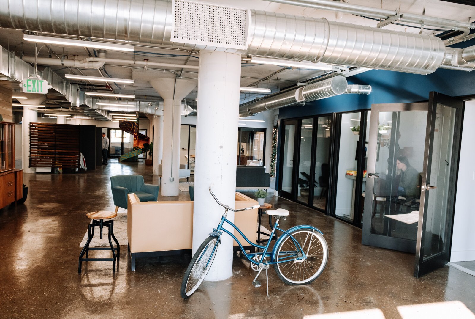 The co working space at Paper Mill Workspace is light and airy and features many different size offices as well as a conference room on the 4th floor above Utopian Coffee.