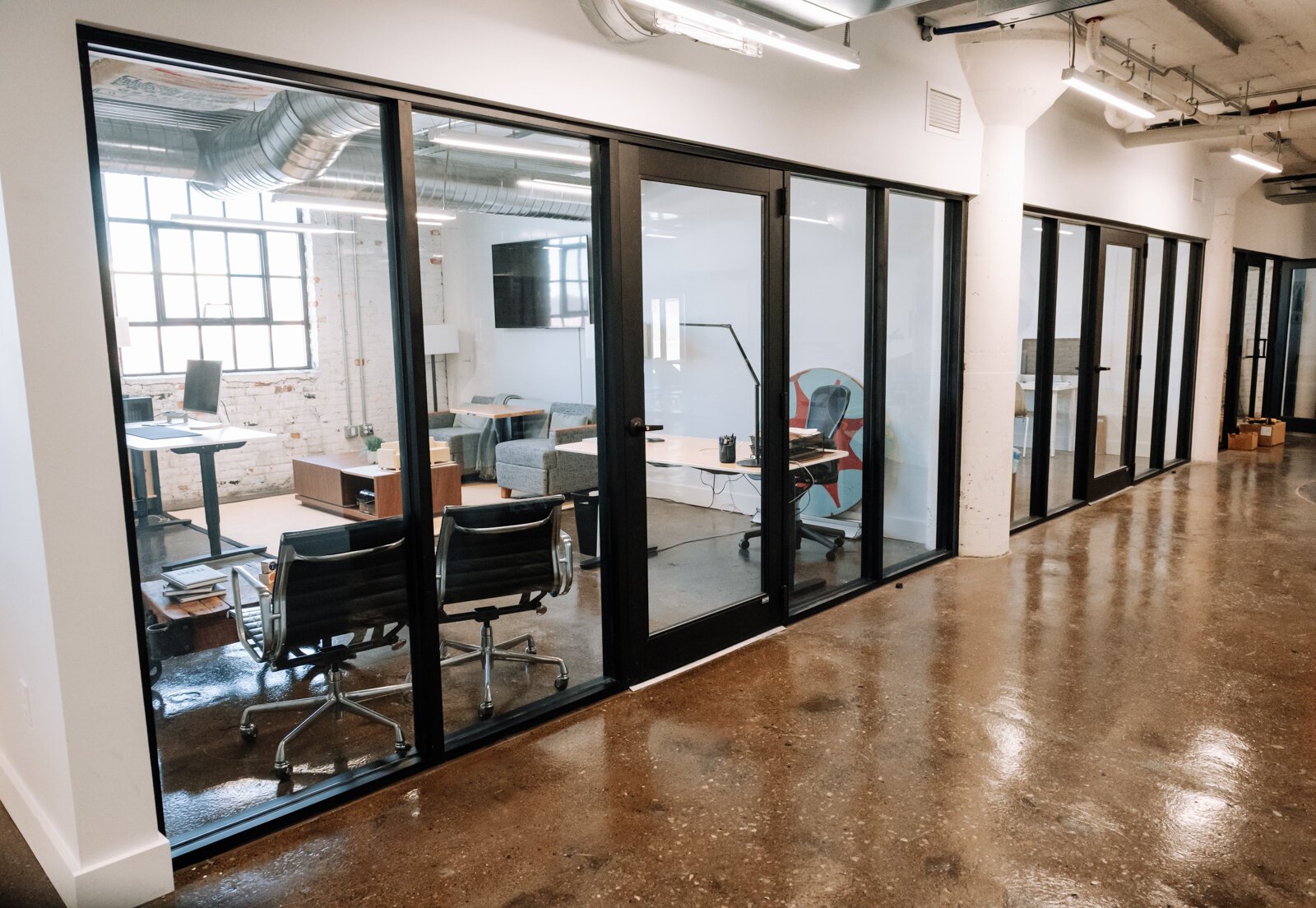 The co working space at Paper Mill Workspace is light and airy and features many different size offices as well as a conference room on the 4th floor above Utopian Coffee.