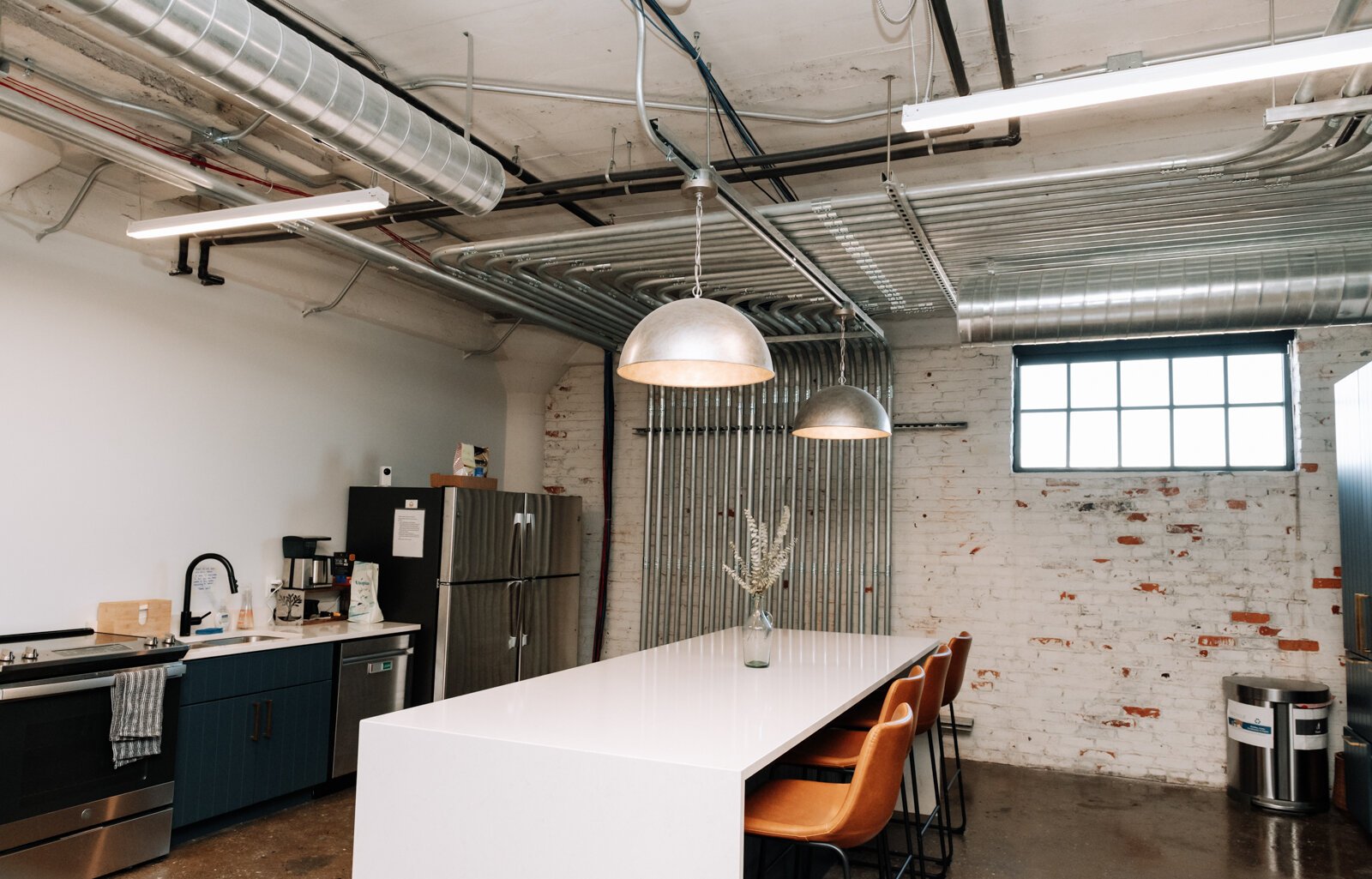 The co working space at Paper Mill Workspace is light and airy and features many different size offices as well as a conference room on the 4th floor above Utopian Coffee.