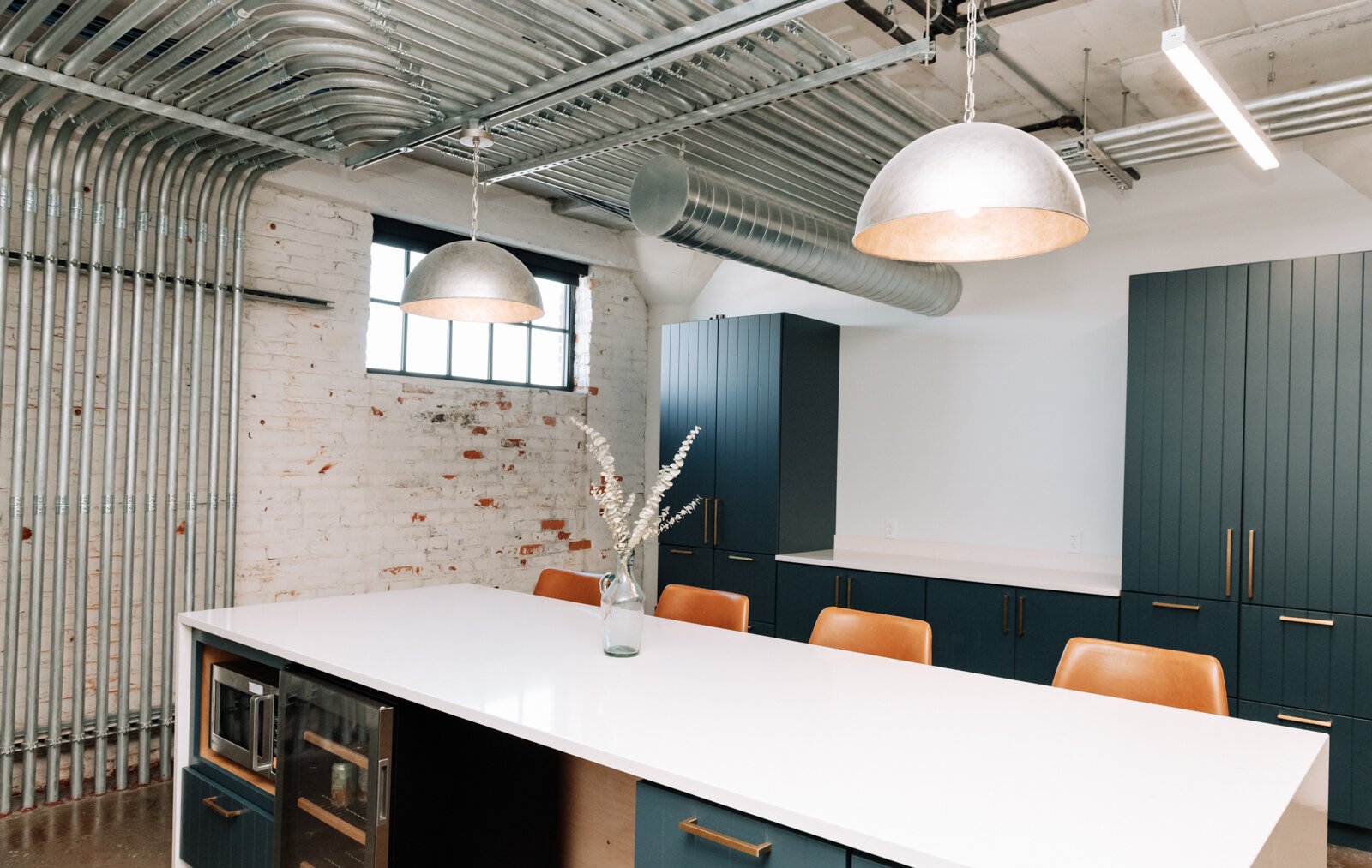 The co working space at Paper Mill Workspace is light and airy and features many different size offices as well as a conference room on the 4th floor above Utopian Coffee.