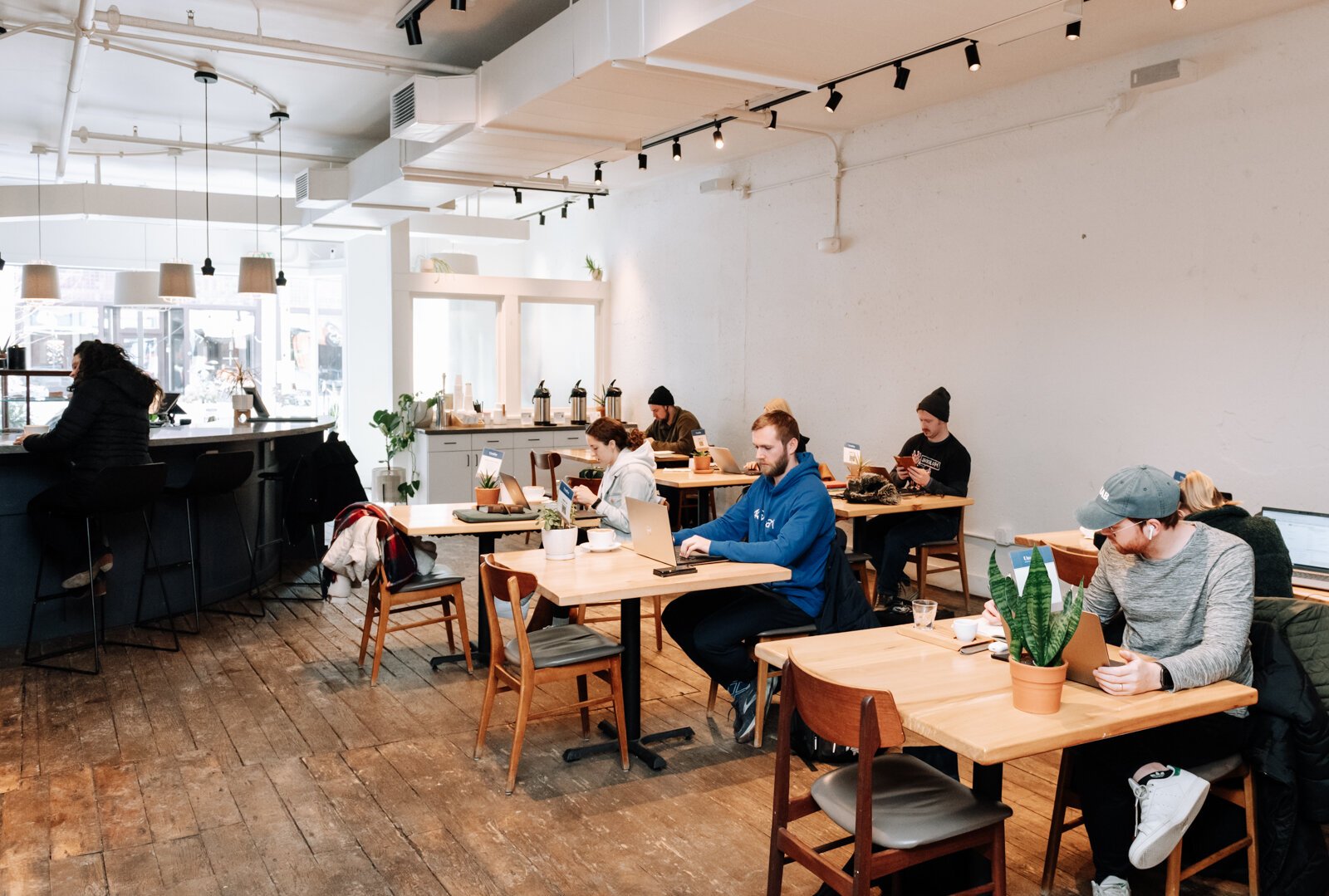 Guests work at the tables at Utopian Coffee.