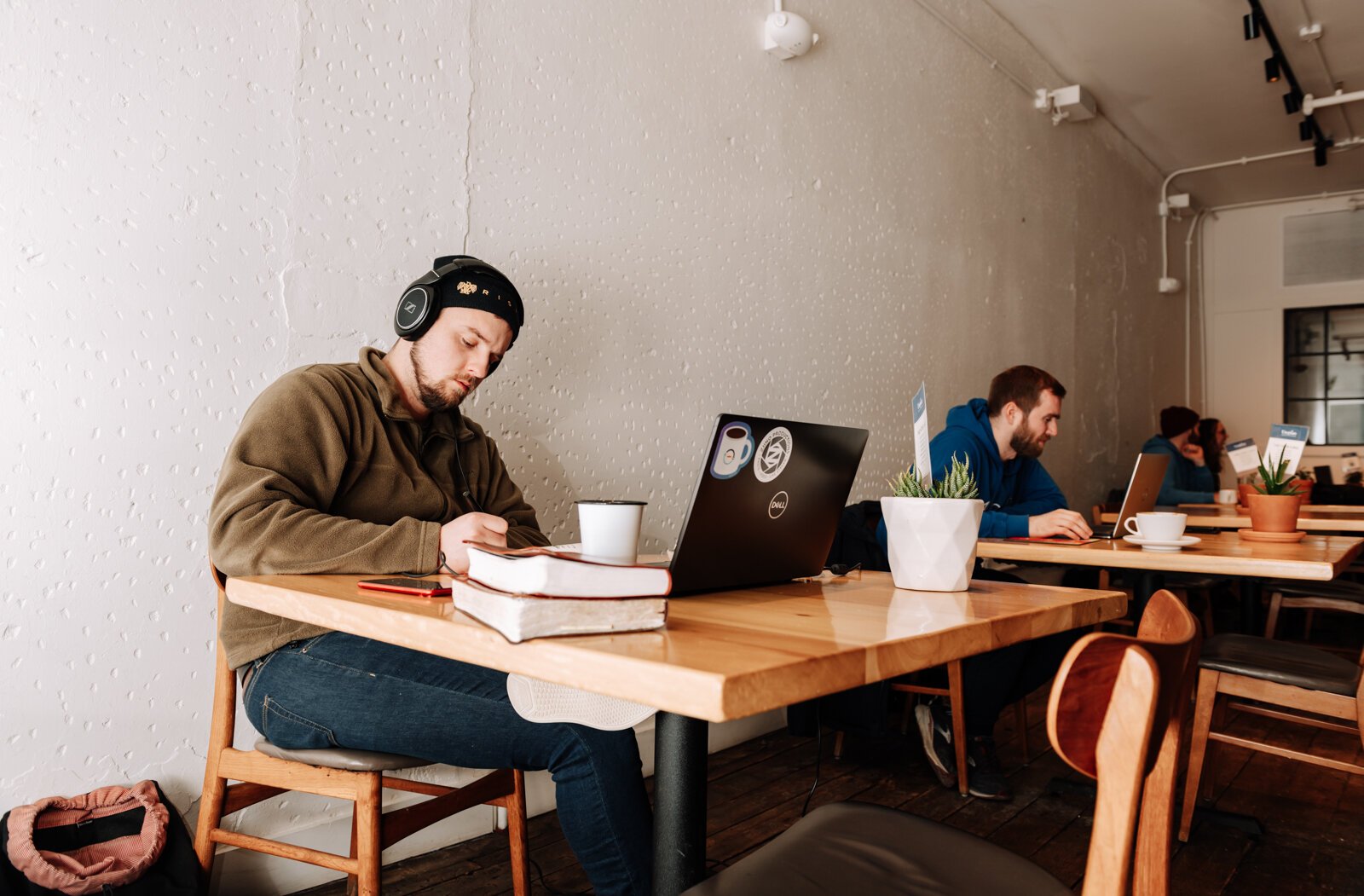 Jesse Crammer works at one of the tables at Utopian Coffee.