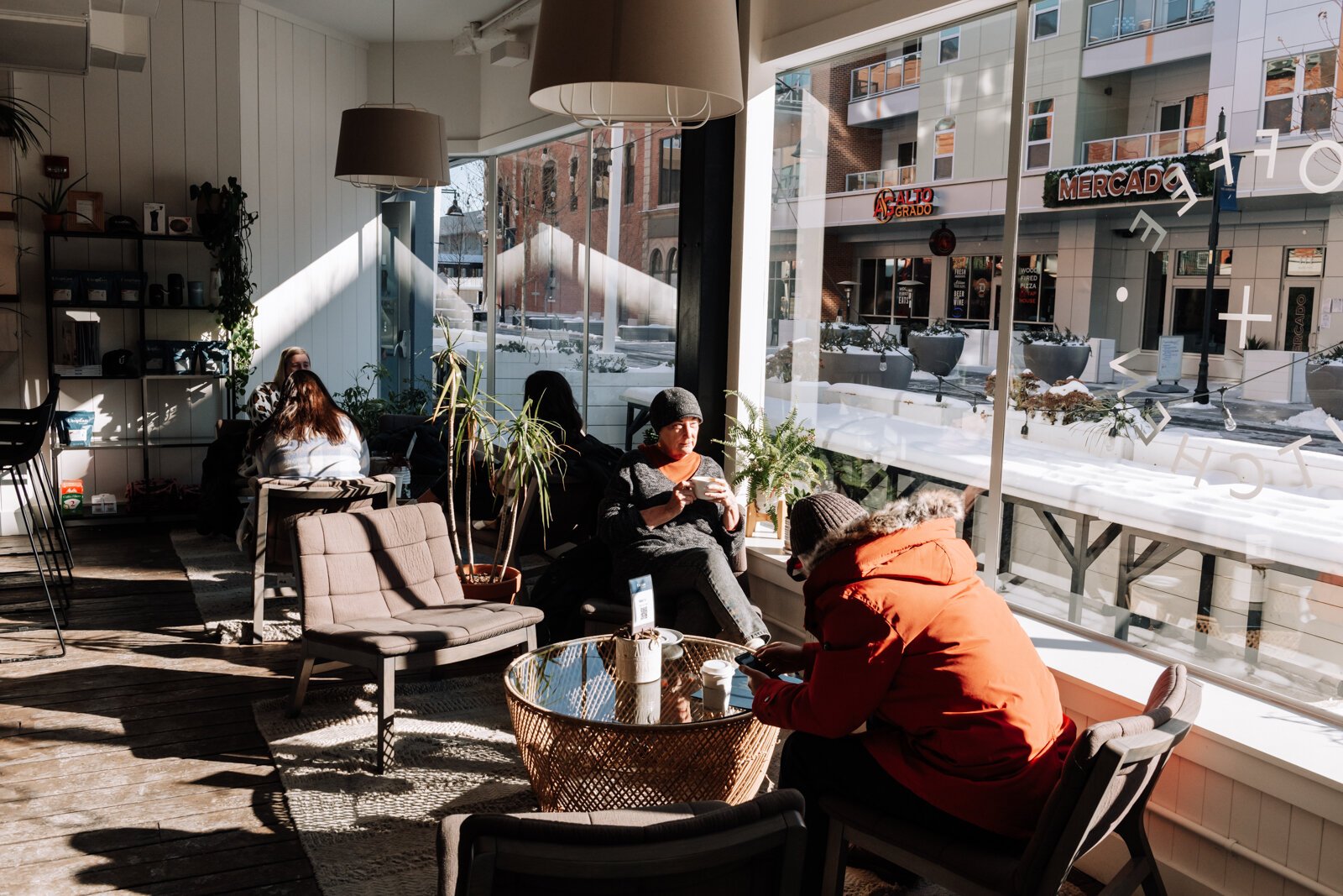 Guests enjoy the natural light at Utopian Coffee.