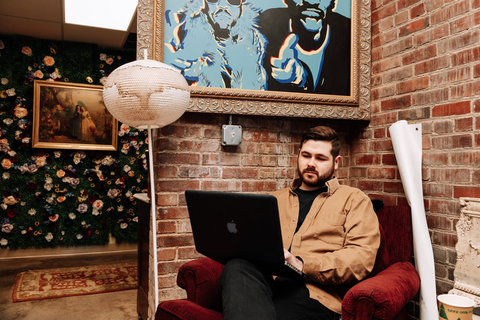 Cameryn Wright utilizes the coziness of the game room at Davey's Delicious Bagels.