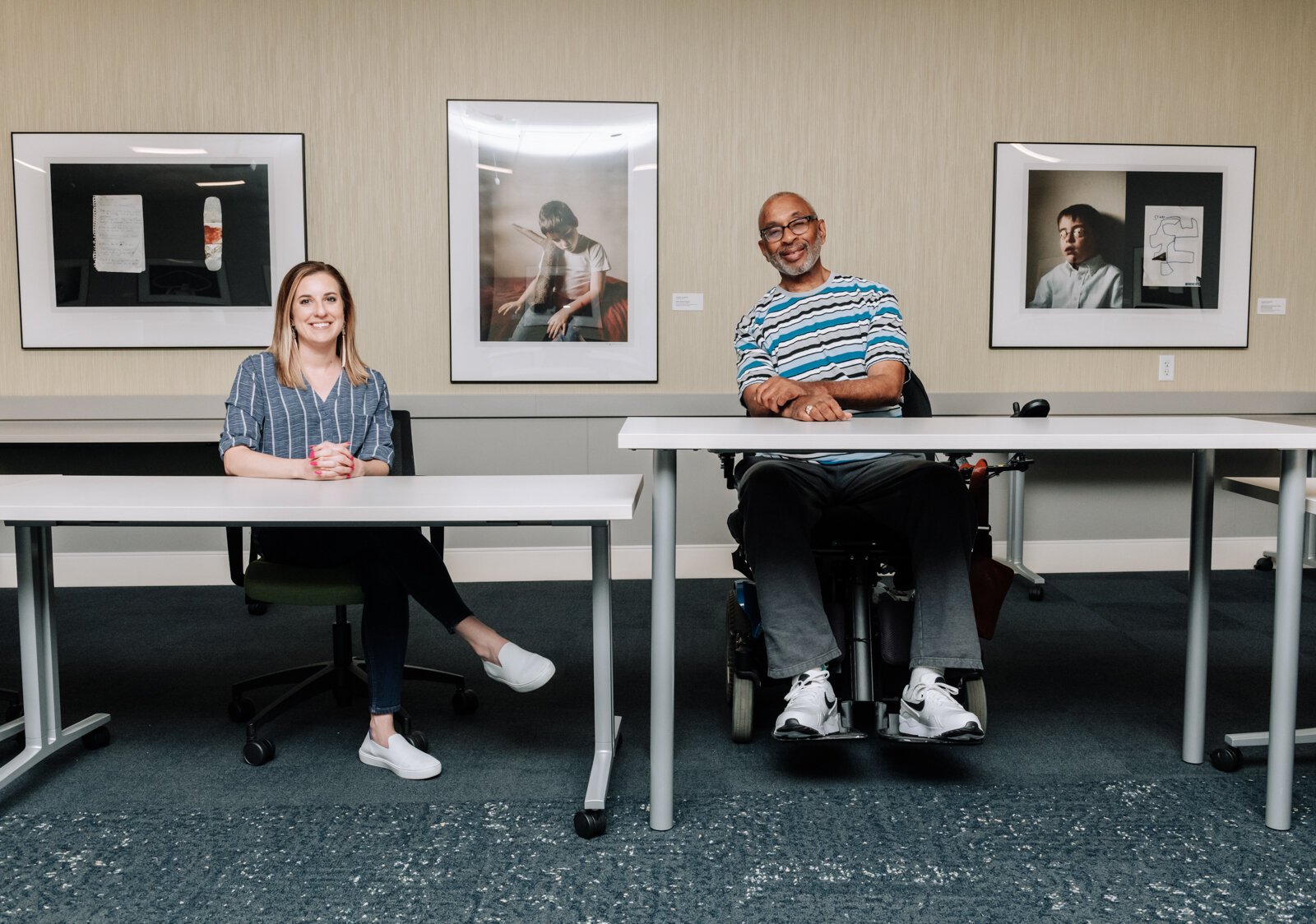 Program Officer for AWS Mandy Drakeford, left, and Clif Wallace showcase how having different levels of tables available and different types of seating is important while at the AWS Foundation.