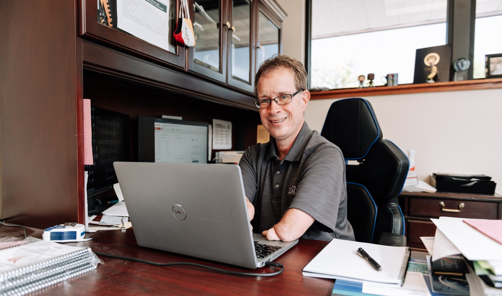 John Guingrich, President/CEO of The League works at his desk at The League For the Blind - Disabled.