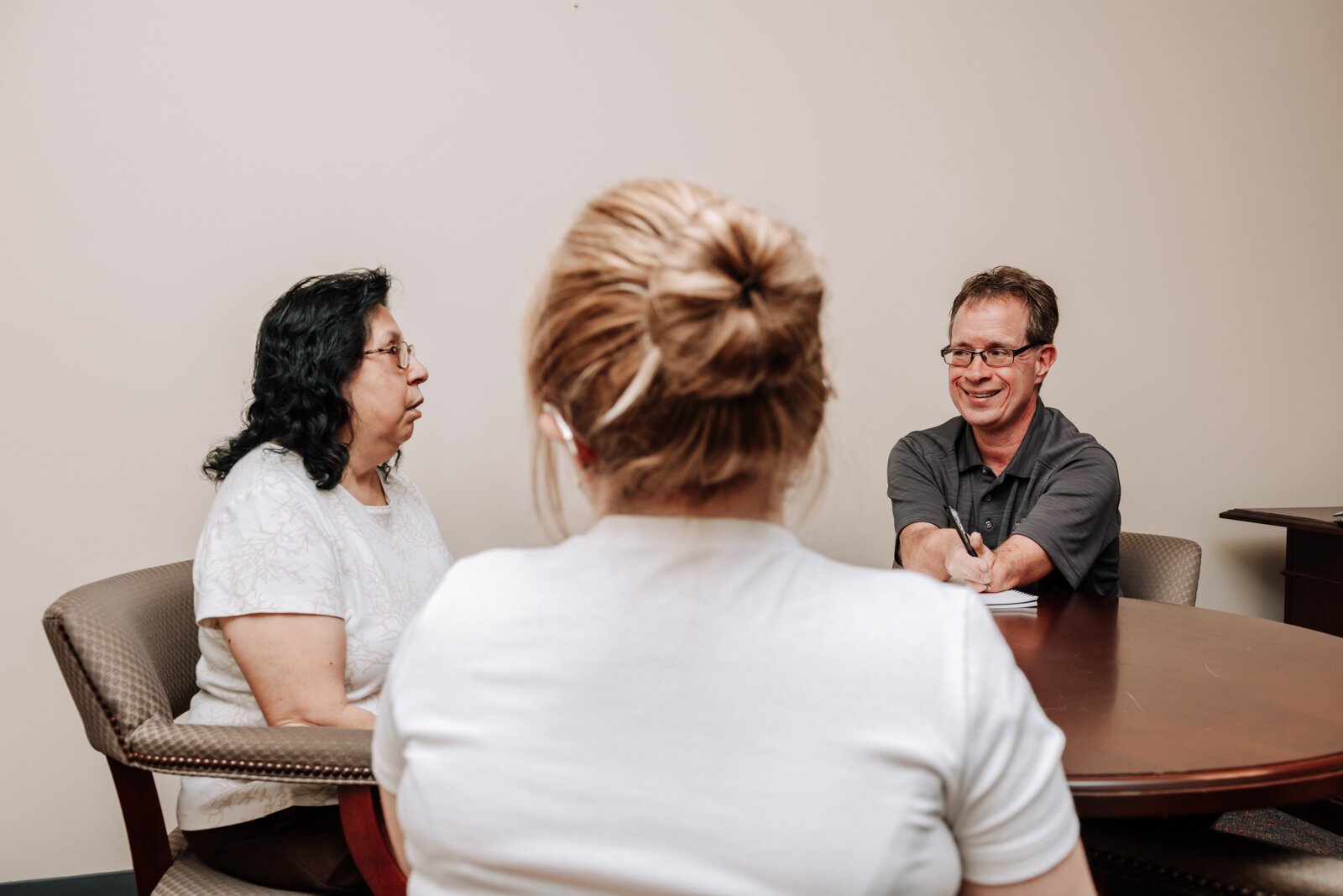 From left: John Guingrich, Moriah Backhaus, and Sylvia Adams have a work meeting at The League For the Blind - Disabled.