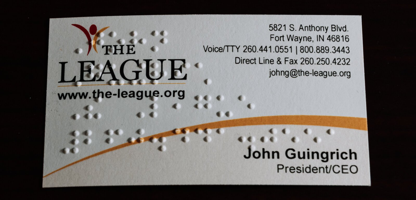 John Guingrich's business card features braille at The League For the Blind - Disabled.