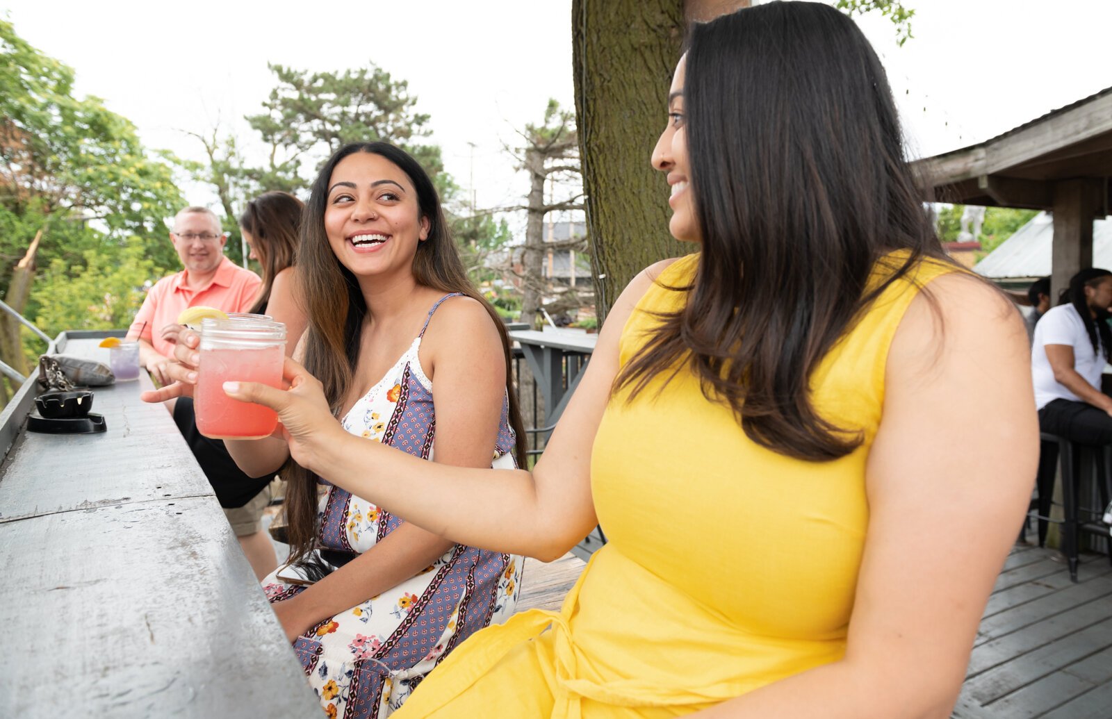 Ashleen Sharma, left, and Riddhi Patel enjoy a drink together at The Deck.
