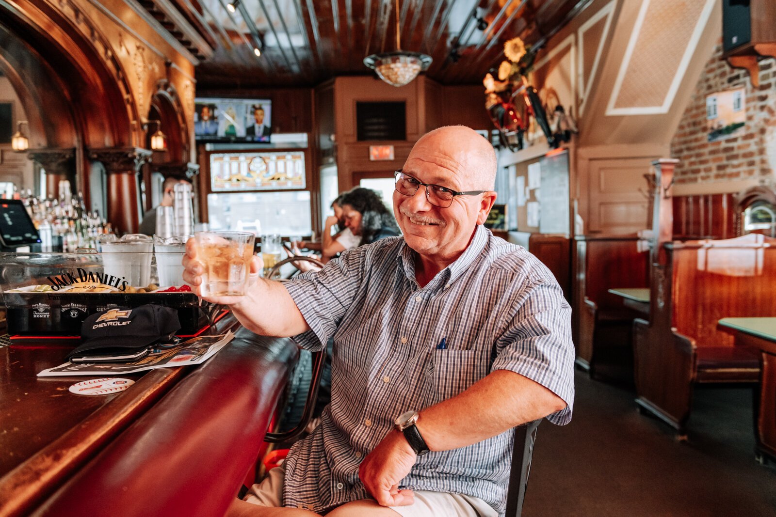 Customer Mark Evans enjoys a (watered down) whiskey at Henry's Restaurant, 536 W. Main St.