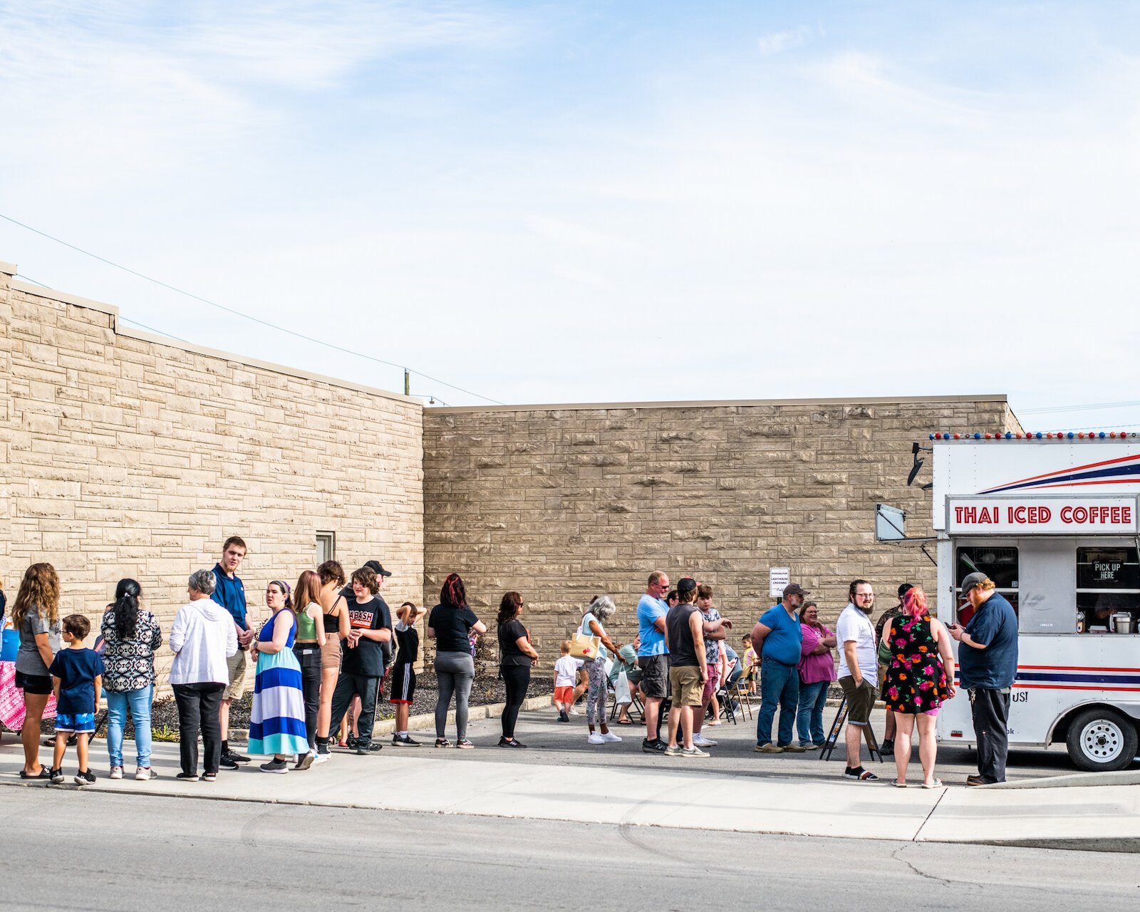 Customers wait in line to order from Tim's Thai 2 Go at First Friday.