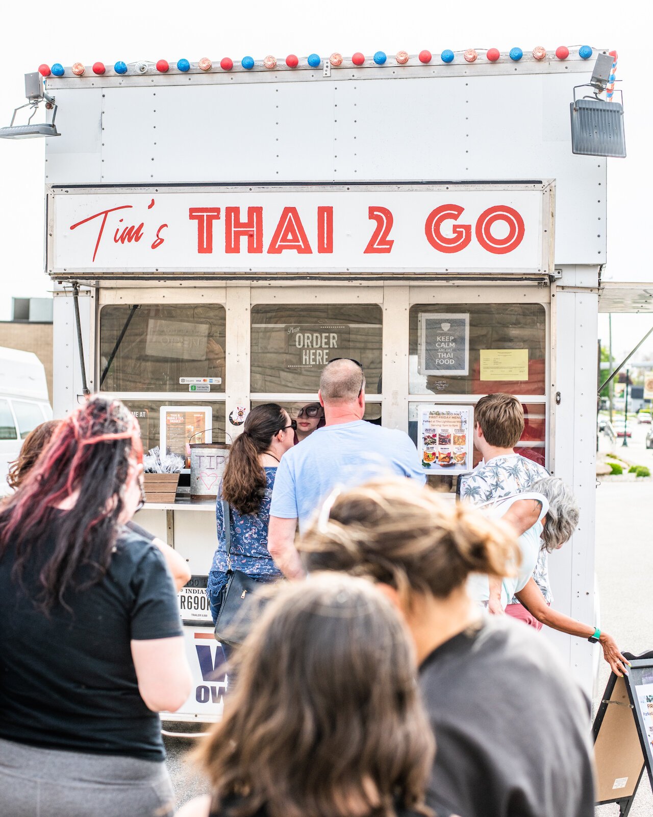 Customers wait in line to order from Tim's Thai 2 Go at First Friday.