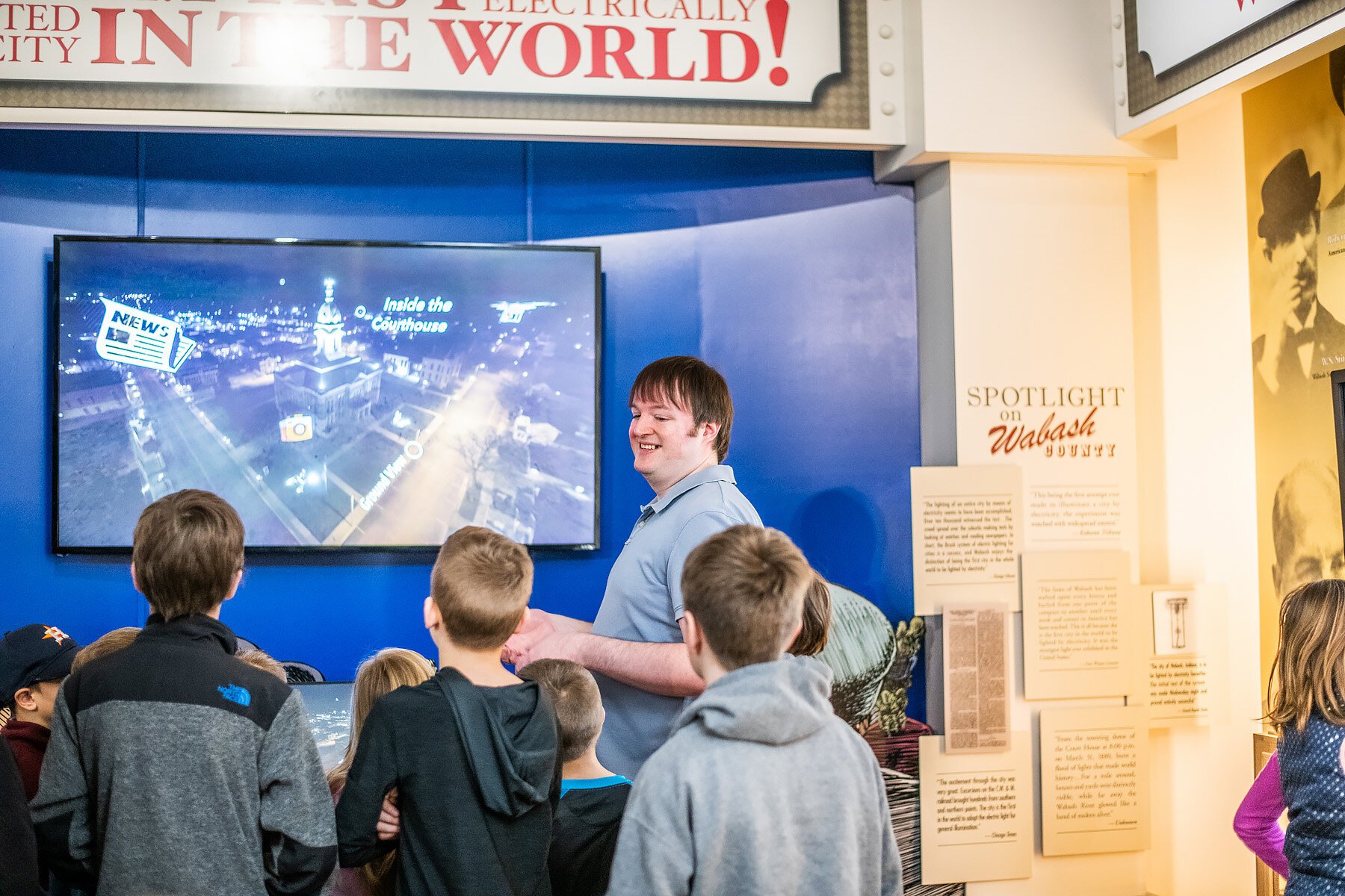 TJ Honeycutt walks visitors through an exhibit.