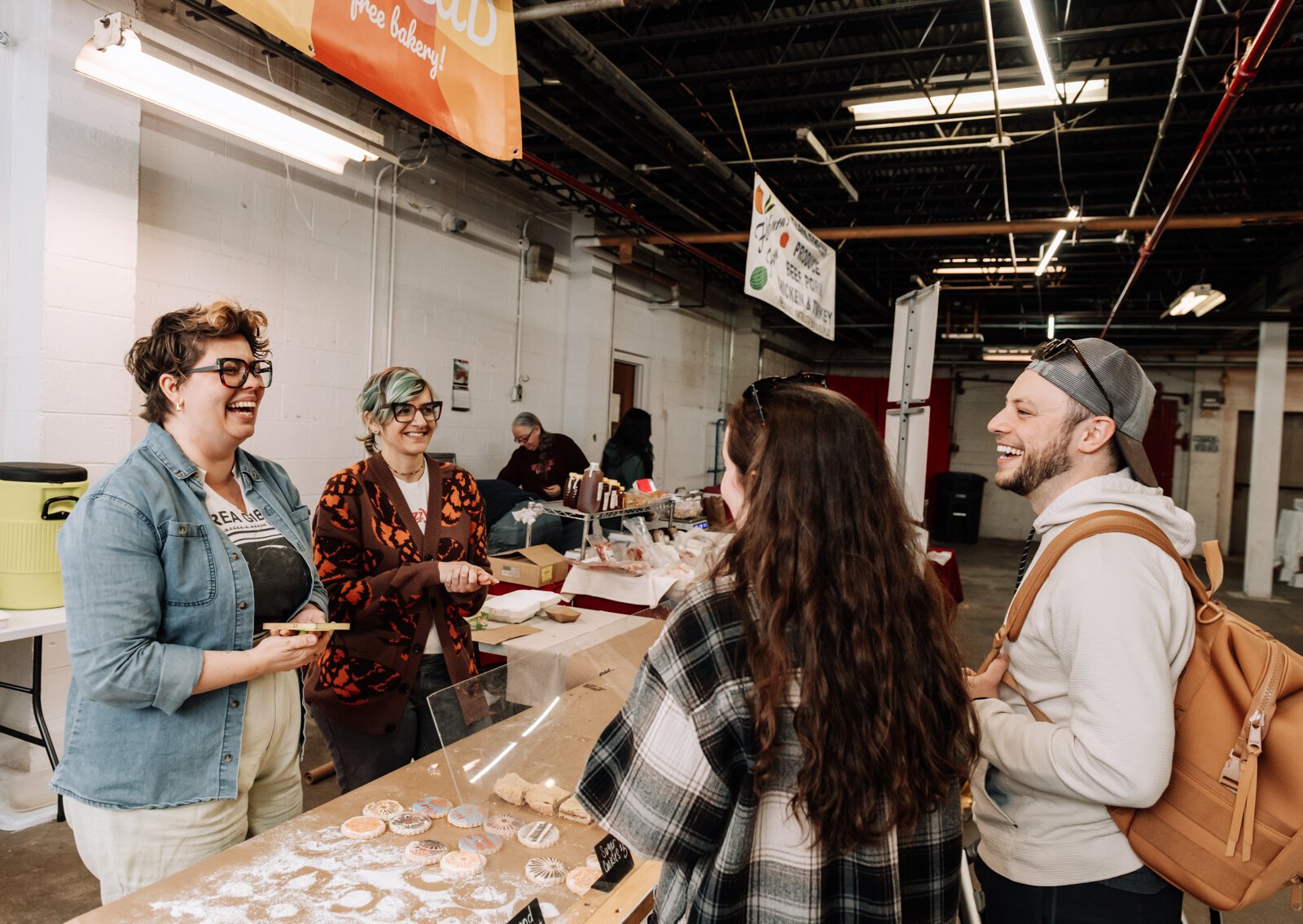 Good Bread for All Owner Sarah Thompson, left, and Lead Baker Mandy Hall help customers during the YLNI Famers Market.