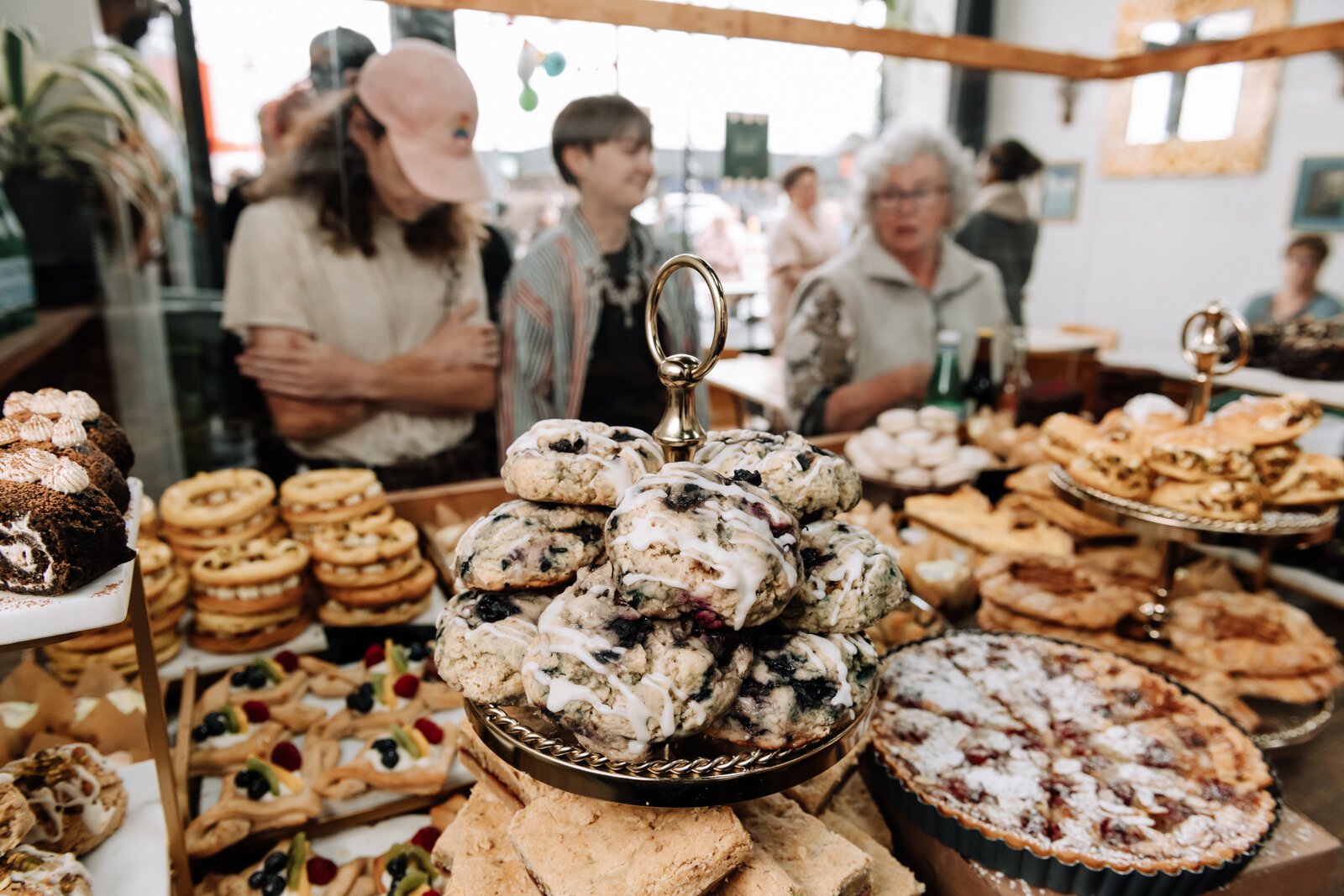 Guests look in at a full case during the grand opening of Good Bread for All, 1016 Broadway, Fort Wayne, IN.