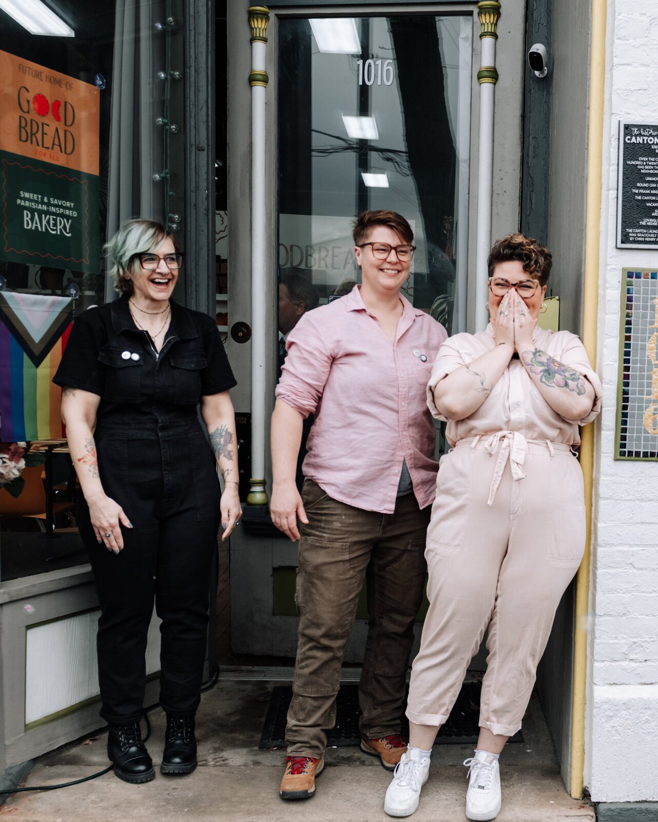 From left: Mandy Hall, Hilary Hontz, and Sarah Thompson react after seeing the crowd of supporters during the grand opening of Good Bread for All.