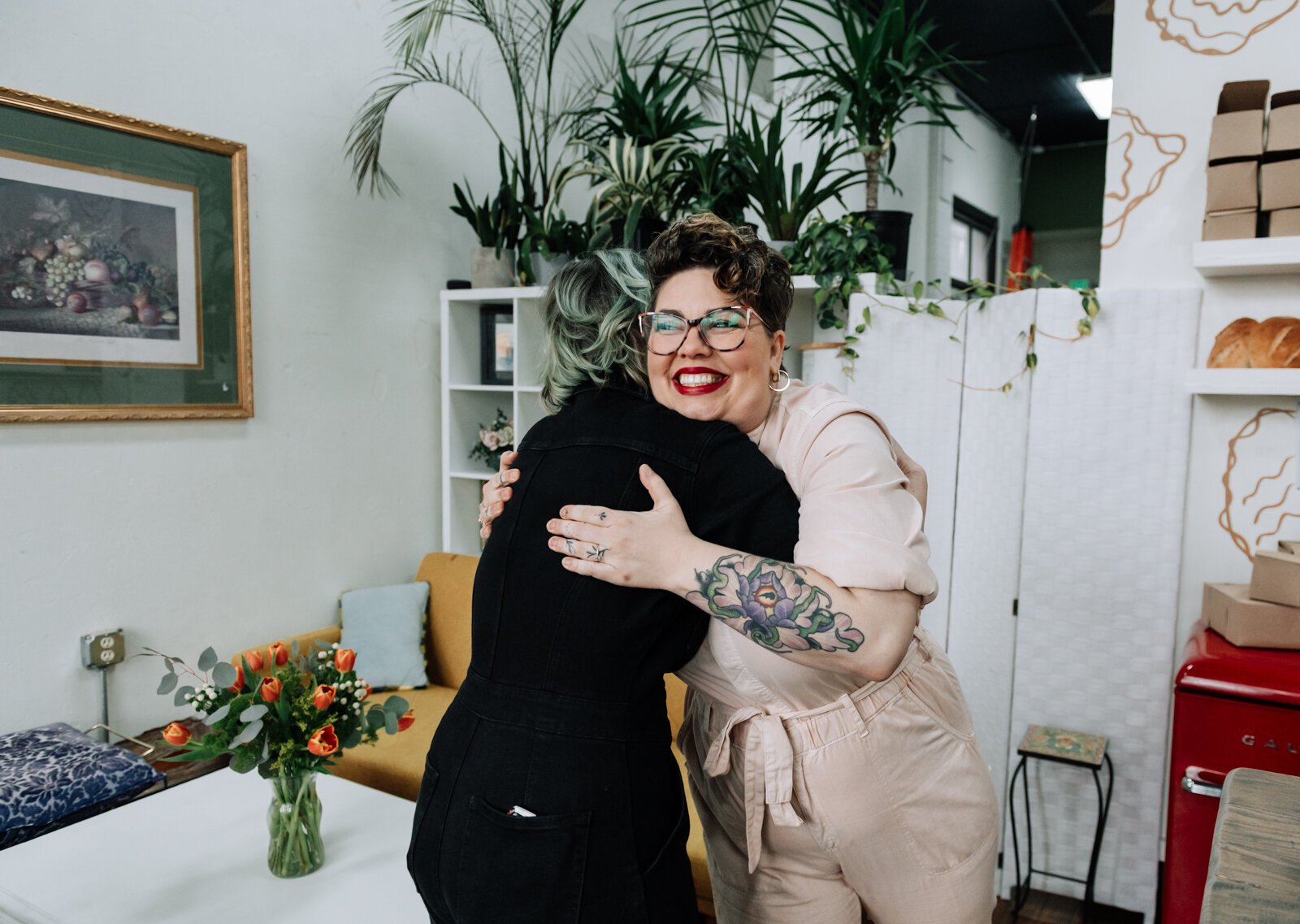 Lead Baker Mandy Hall, left, and Owner Sarah Thompson celebrate after cutting the official ribbon during the grand opening of Good Bread for All.