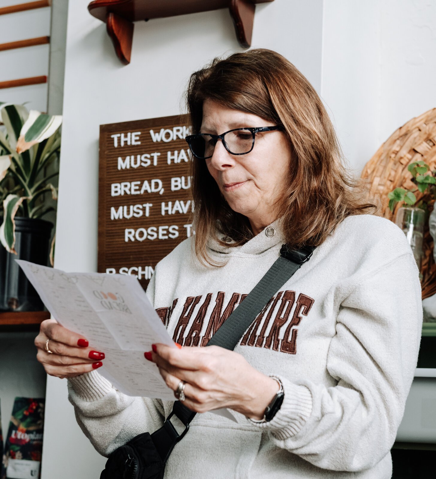 Jodi Fester takes a look at the menu while waiting in line at Good Bread for All.