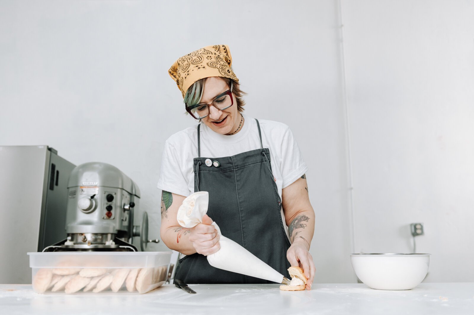 Lead Baker Mandy Hall works on filling a pistachio crème puff.
