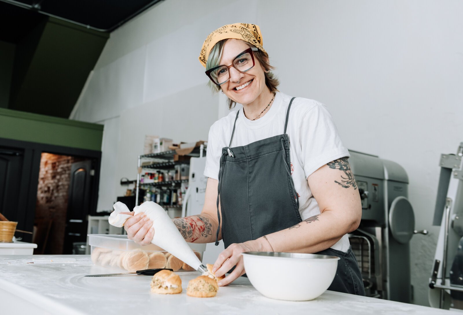 Lead Baker Mandy Hall works on filling a pistachio crème puff.