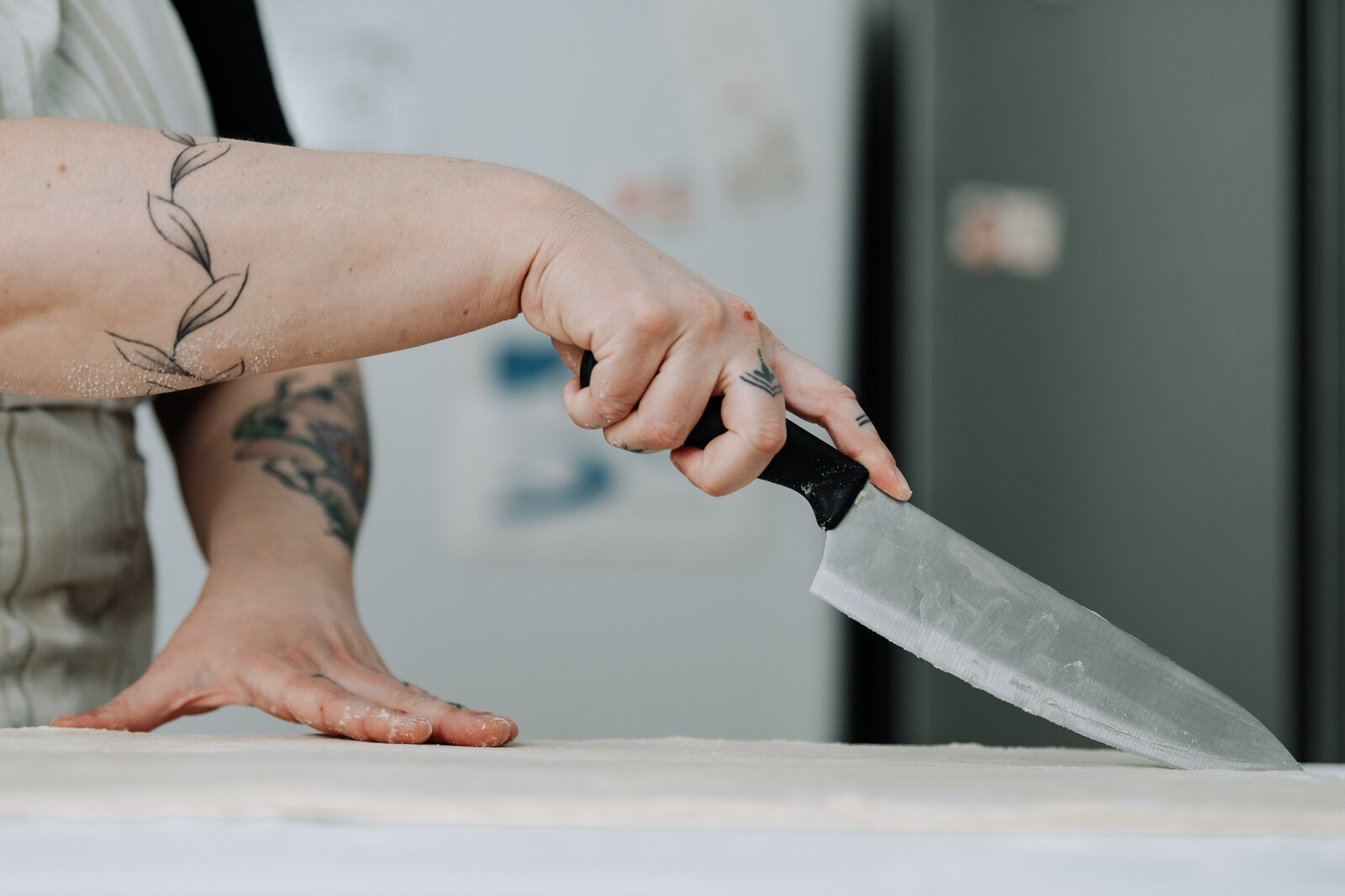 Owner Sarah Thompson works on cleaning up the edges of her croissants.