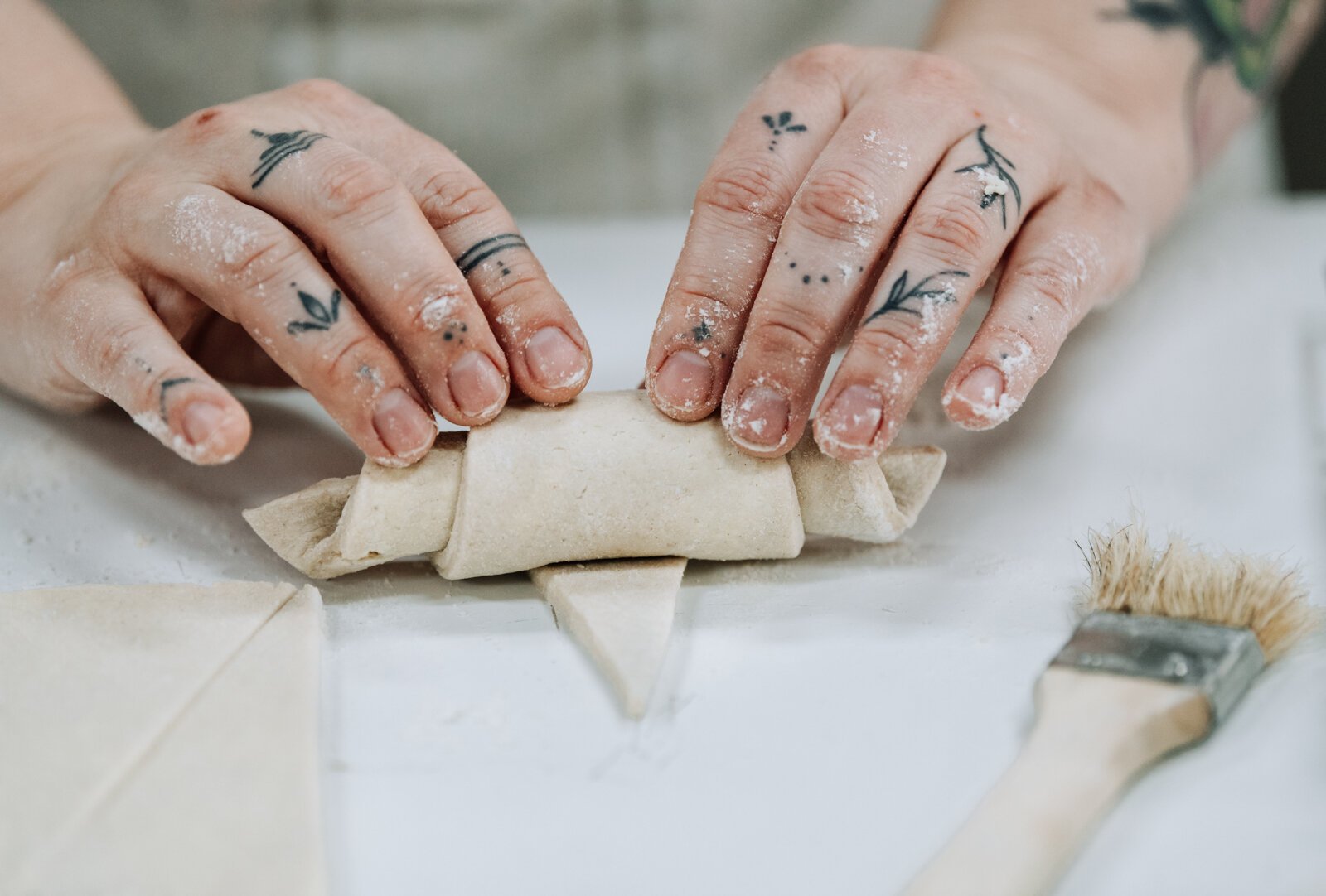 Good Bread for All Owner Sarah Thompson rolls up croissants.