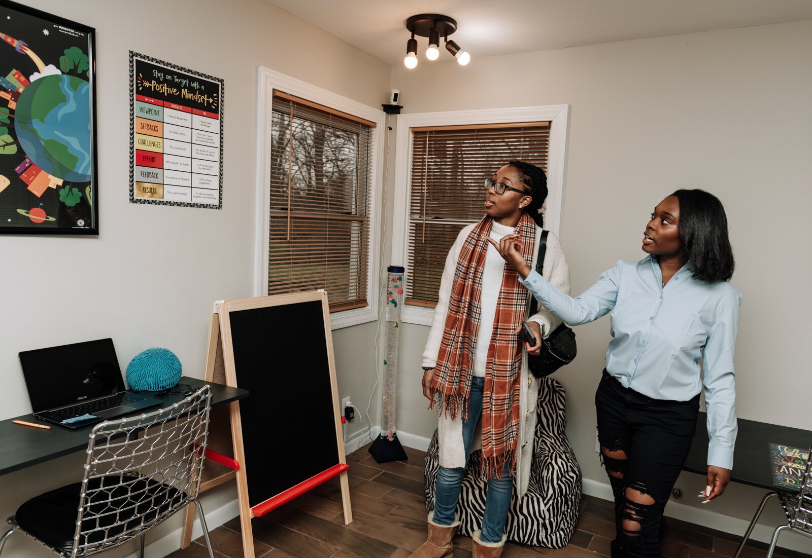 Lauryn Jones, right, shows Janae McGill the computer room during the open house and ribbon cutting of Hands on Haven Inc.