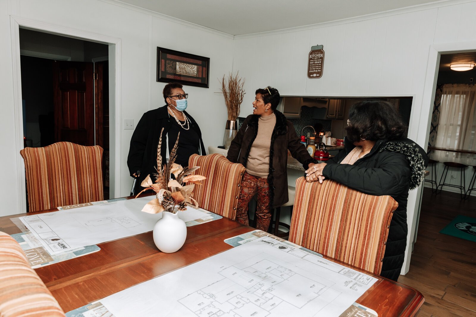 From left: Renetta Williams, Cindy White, and Carla Harrison chat in the dining room area during the open house and ribbon cutting of Hands on Haven Inc.