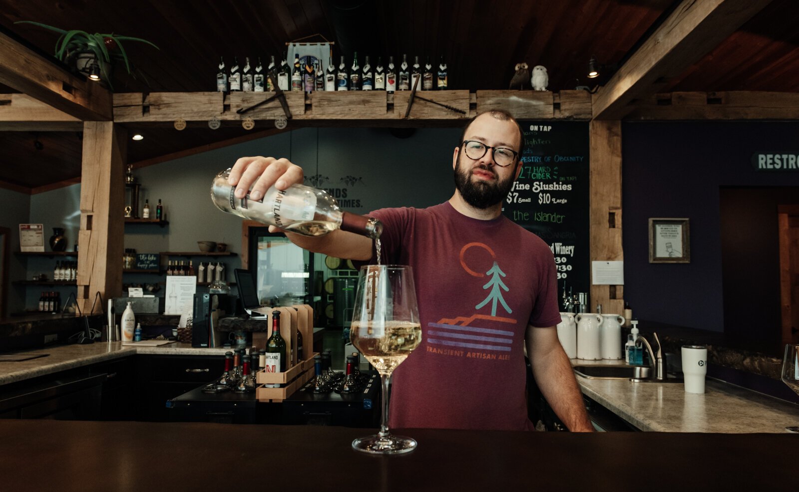 inemaker Kirk Etheridge pours an estate grown Lacrescent at Hartland Winery in Ashley, IN.