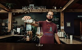 inemaker Kirk Etheridge pours an estate grown Lacrescent at Hartland Winery in Ashley, IN.