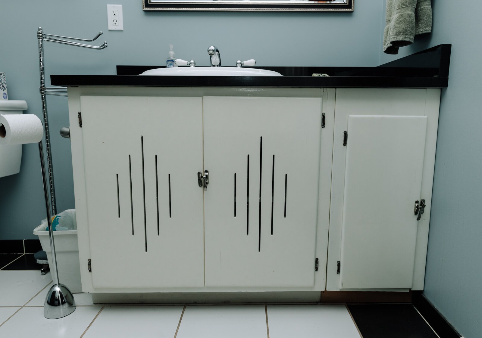 The bathroom in Amy Beatty's accessory dwelling unit features cabinets that were from the original kitchen from 1928. The unit was added on in 2012 to accommodate her mother.