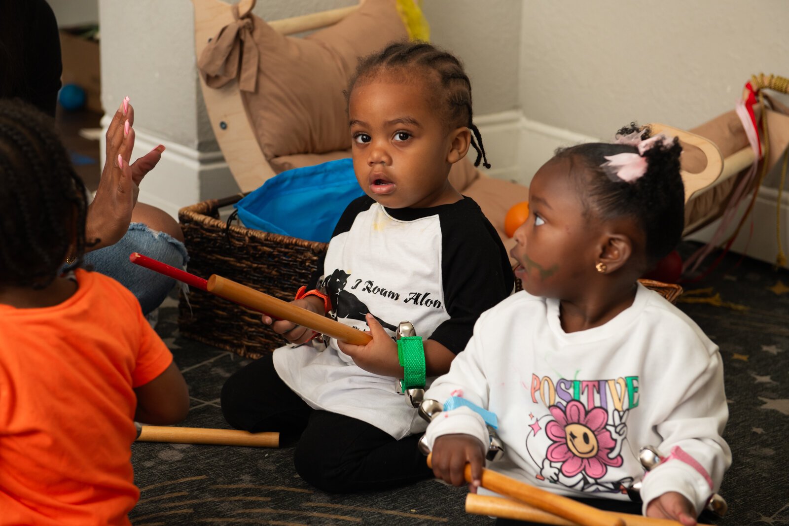 Asir, center, drums during Circle Time featuring songs and music with Janae Dubose, owner of Little Achievers Home Daycare Kindergarten Prep.