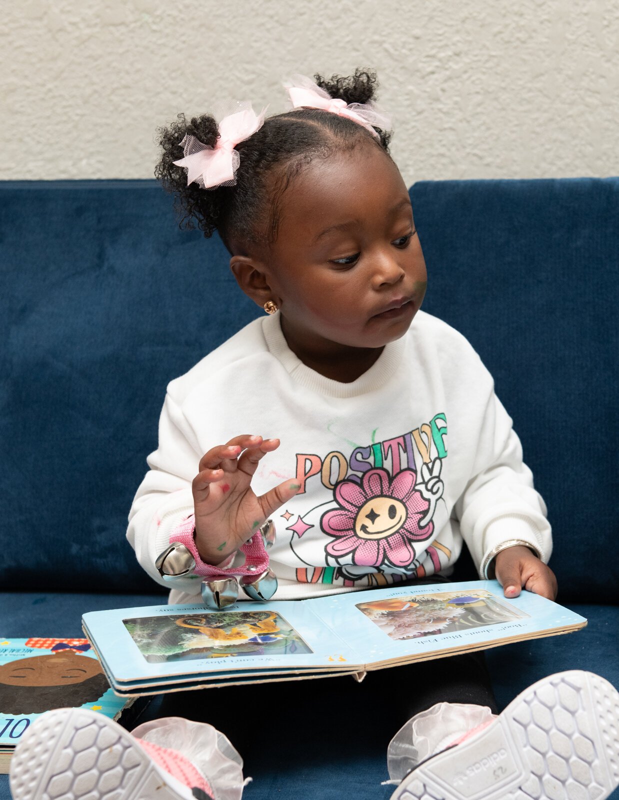 Amora, enjoys reading during an activity at Little Achievers Home Daycare Kindergarten Prep.