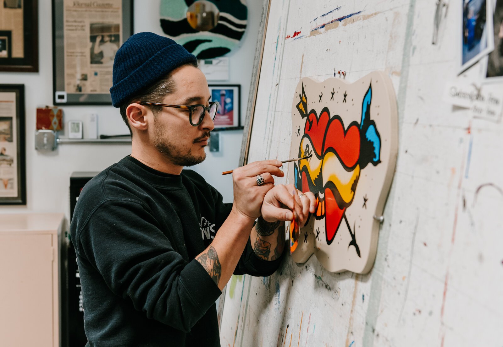 Justin Lim, Sign painter and owner of Old 5 and Dime Sign Co., works on a First Friday sign for a customer at his shop in downtown Fort Wayne.