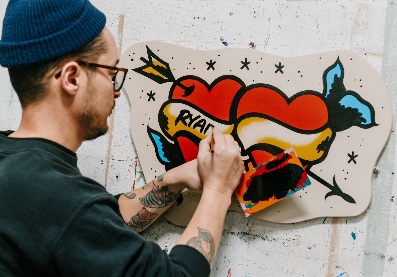 Justin Lim, Sign painter and owner of Old 5 and Dime Sign Co., works on a First Friday sign for a customer at his shop in downtown Fort Wayne.