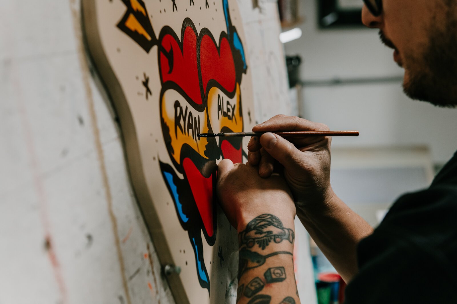 Justin Lim, Sign painter and owner of Old 5 and Dime Sign Co., works on a First Friday sign for a customer at his shop in downtown Fort Wayne.