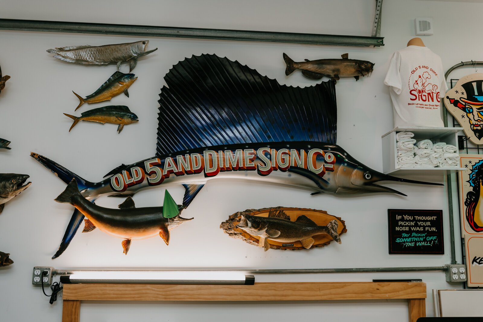 Hand painted signs featuring Justin Lim’s business name, Old 5 and Dime Sign Co., at his shop in downtown Fort Wayne.