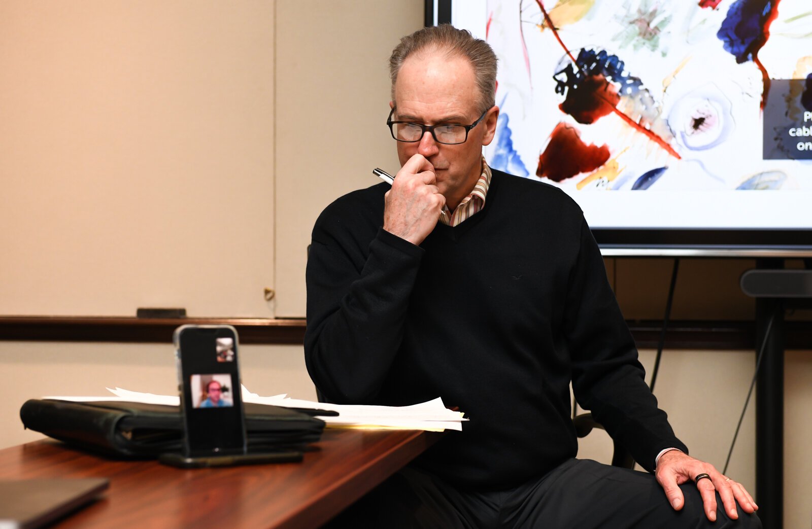 Tim Brown listens while one of the members speaks via Zoom during a council meeting with members of the Mayor's Age-Friendly Council at Citizen's Square.