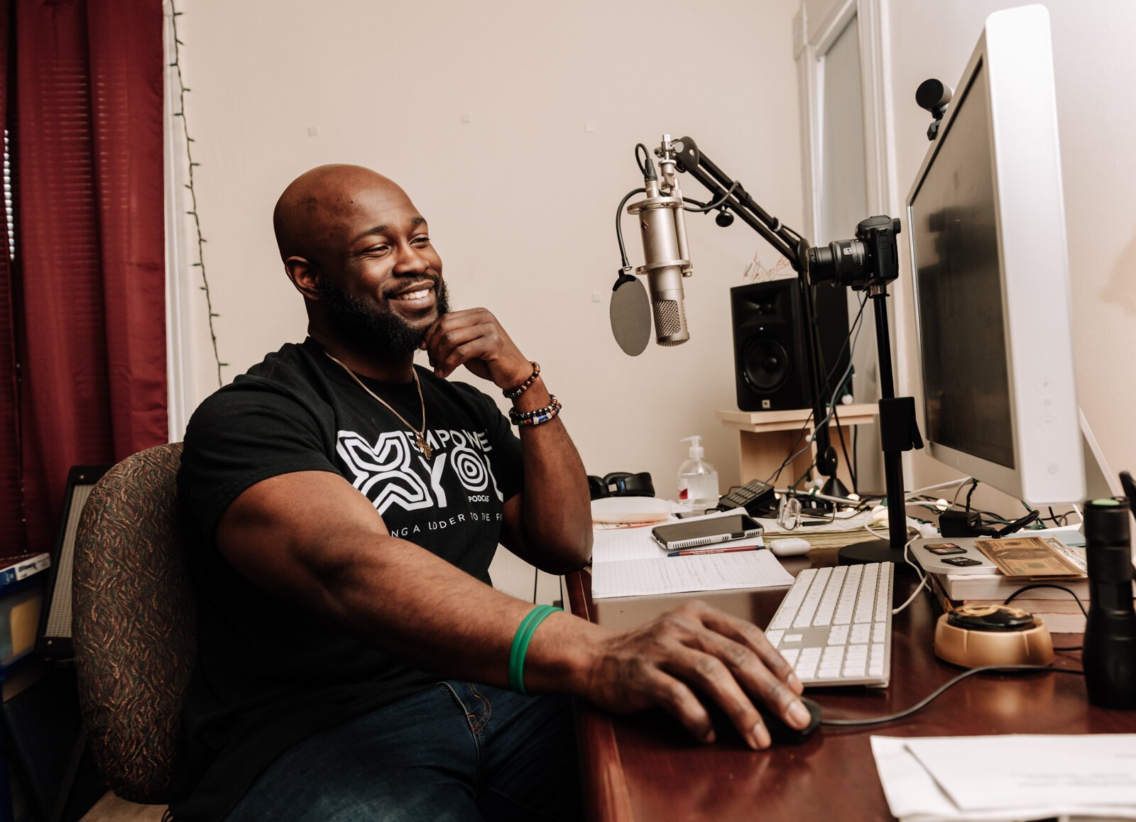 Kibwe Cooper, the host of 'Empower You Podcast', works on a podcast in his studio at home.